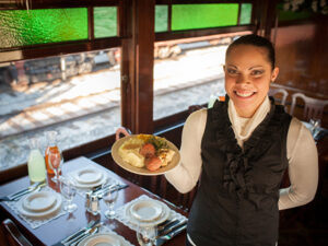 One of the servers at the Strasburg Rail Road getting ready to serve a meal aboard the dining car.