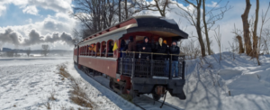 A train traveling on snow-covered tracks.