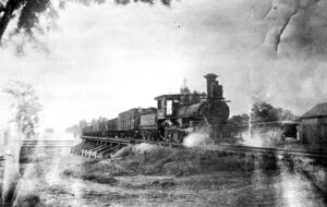 A vintage photo of a steam engine on the tracks at the Strasburg Rail Road.