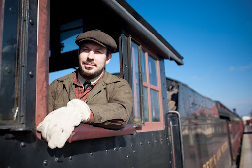 A train locomotive engineer looking out of the train window at the Strasburg Rail Road.