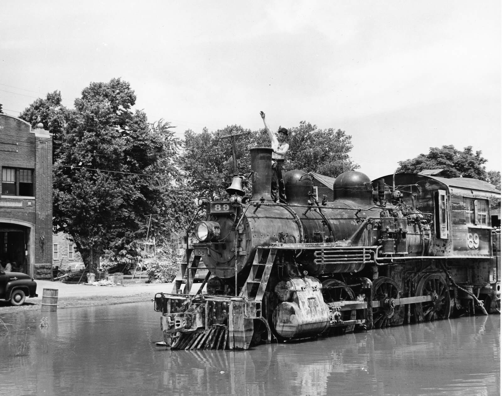 A vintage photo of engine 89 flooded on the train tracks after a storm.