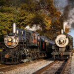 steam engines 89 and 475 on the train tracks side-by-side.