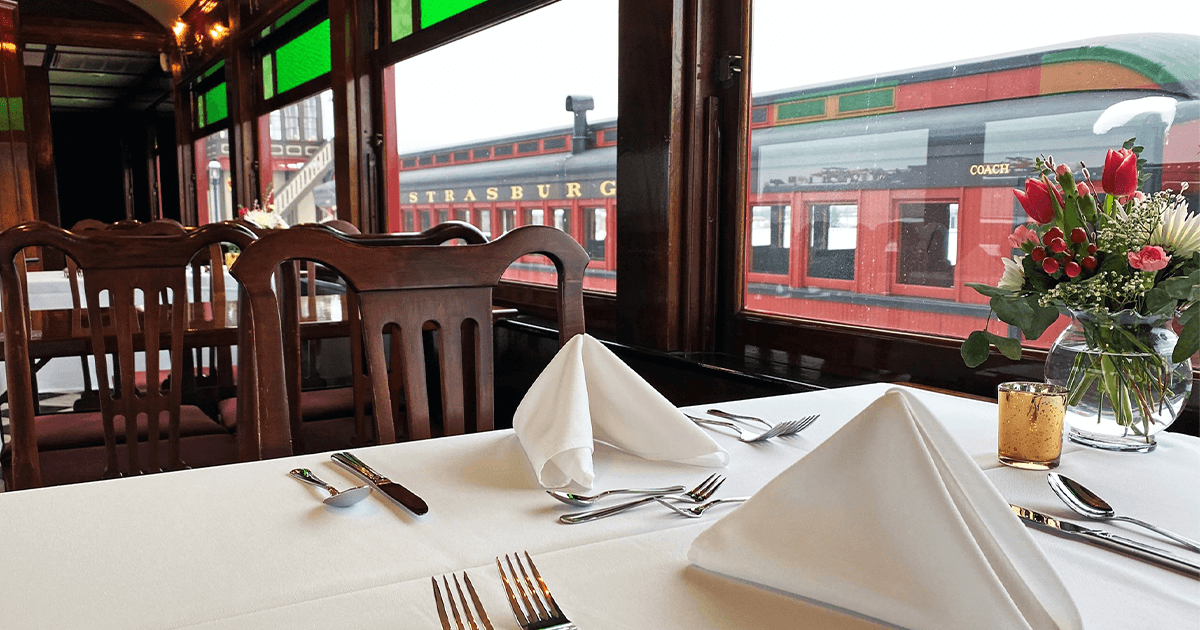 A dining table set in Strasburg Rail Road's Dining Car.
