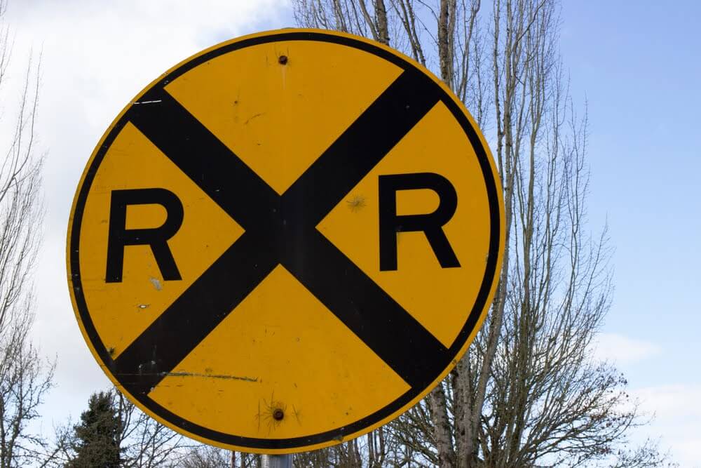 A close up of a passive railroad sign.