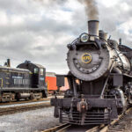 Steam engine #475 is sitting on a train track.