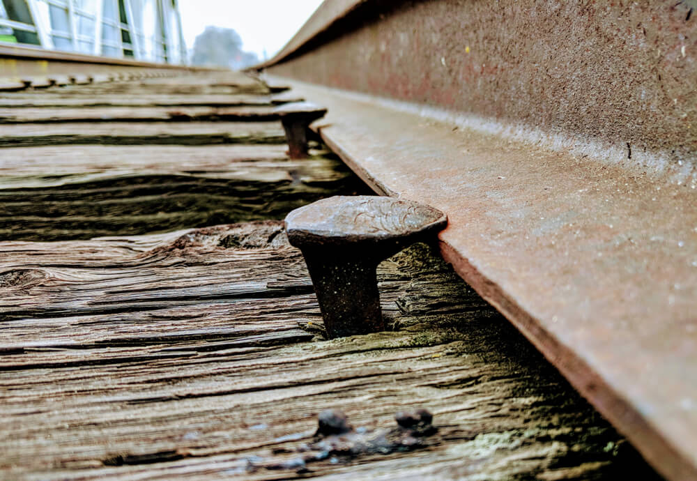 Railroad spikes securing the tracks in place.